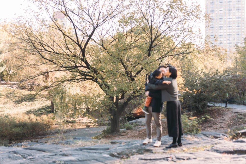 A blurry picture of a family hugging in Central Park NYC