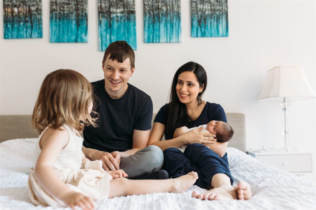 Newborn photoshoot of a family in their NYC bedroom