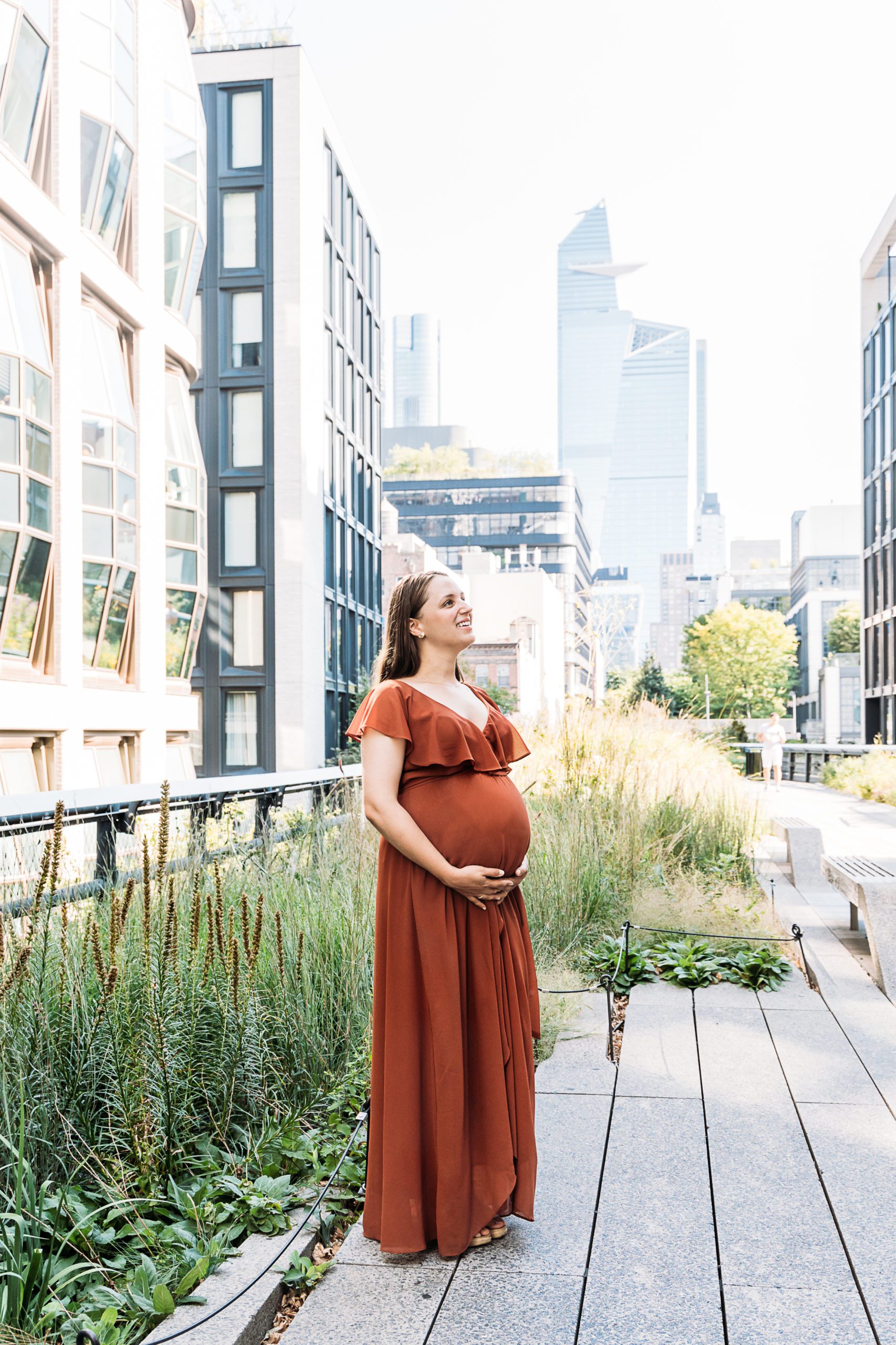 Burnt Orange Maternity Dress on a pregnant mother in New York City at Highline Park during their NY family photo session