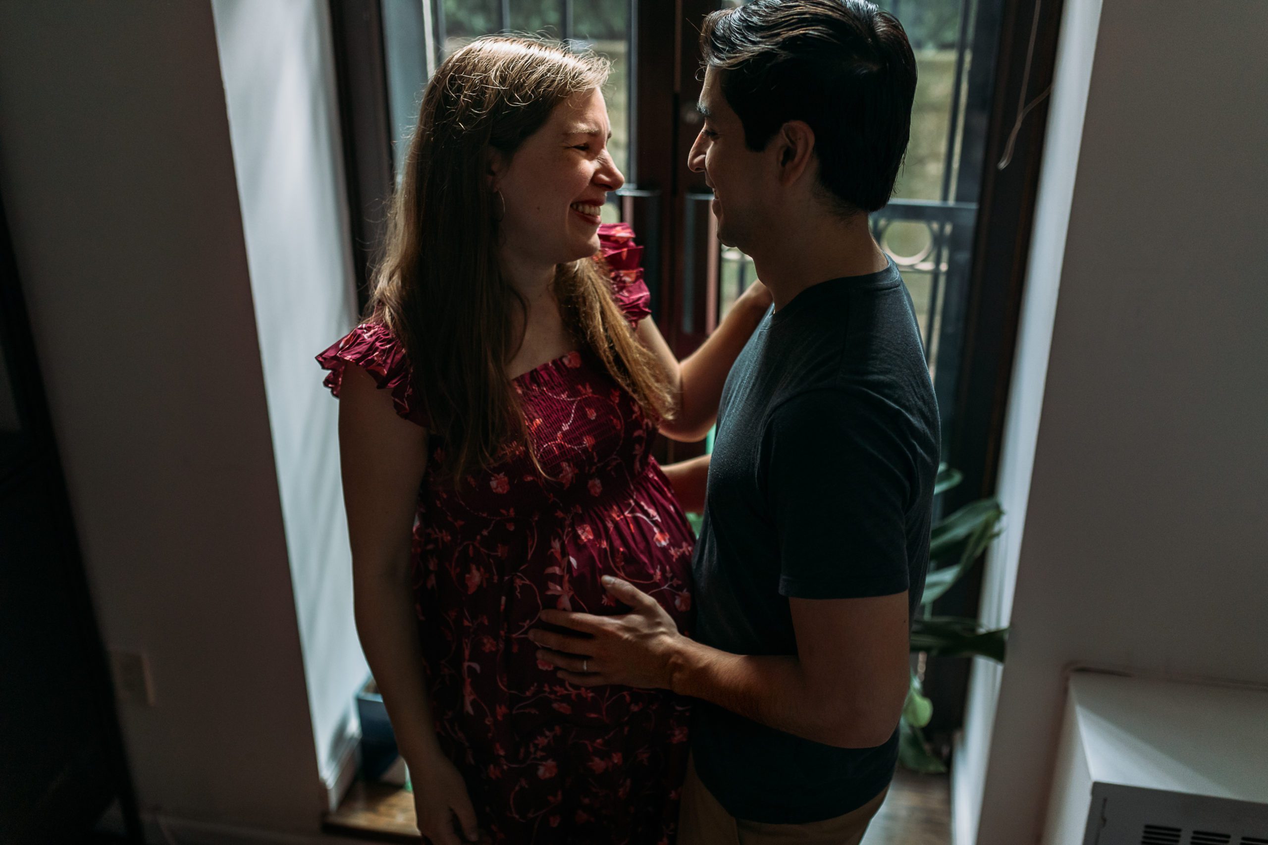 Husband and wife are expecting a baby and posing at home in their New York City home during their Maternity Photoshoot with Amy Nghe Photography, Westchester County Family, Newborn, and Maternity Photographer